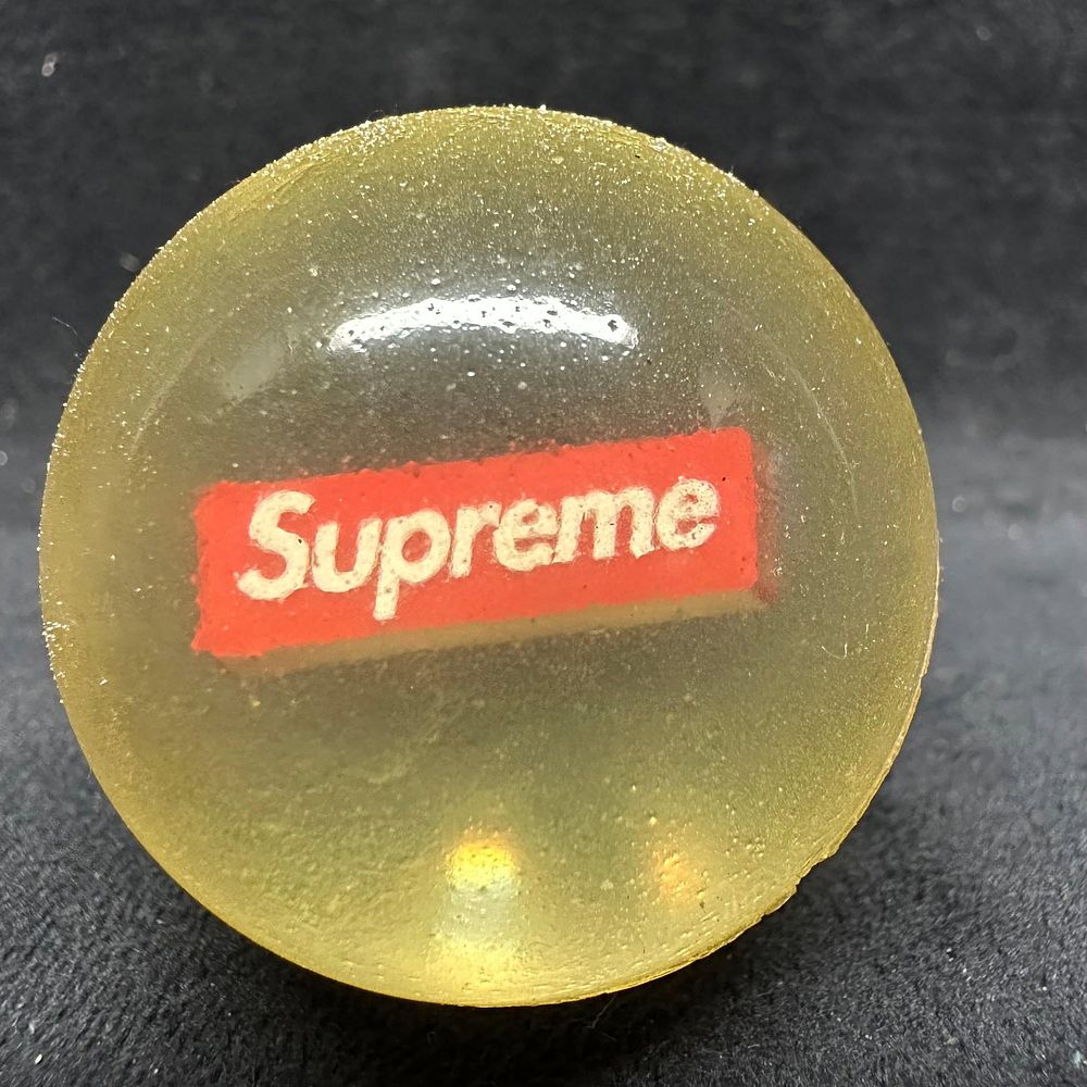 Lot 434: Supreme Translucent Logo Bouncy Ball with 23 Drawstring Pouch