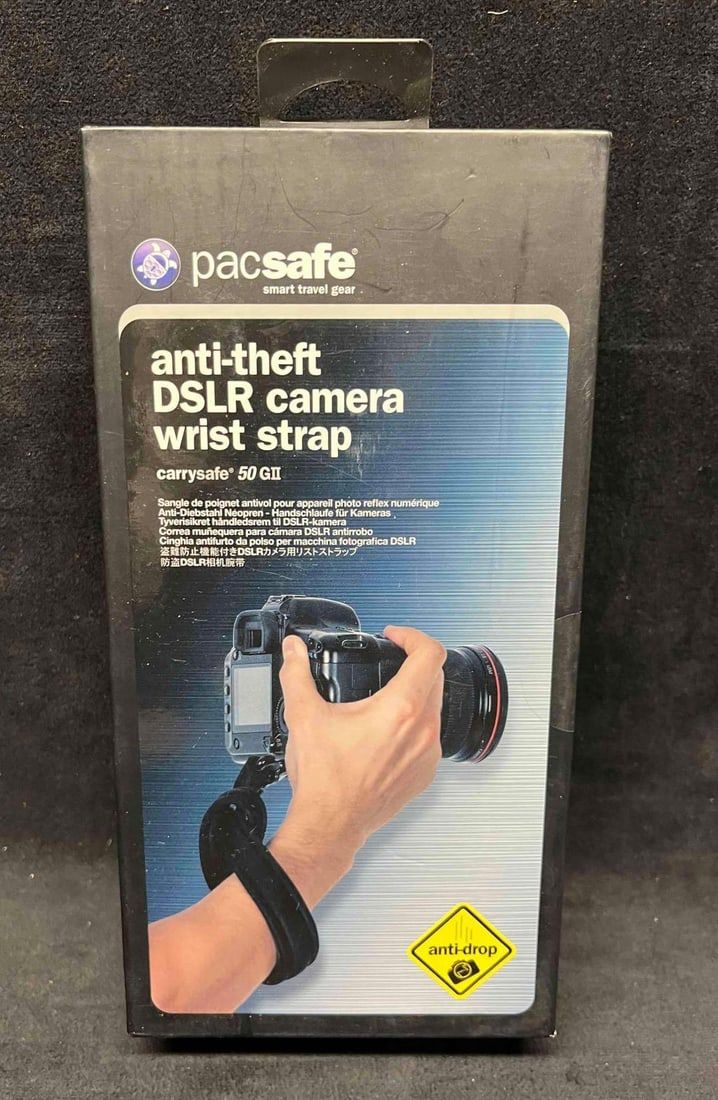 Lot 186: PacSafe Anti-Theft DSLR Camera Wrist Strap Sealed In Original Box