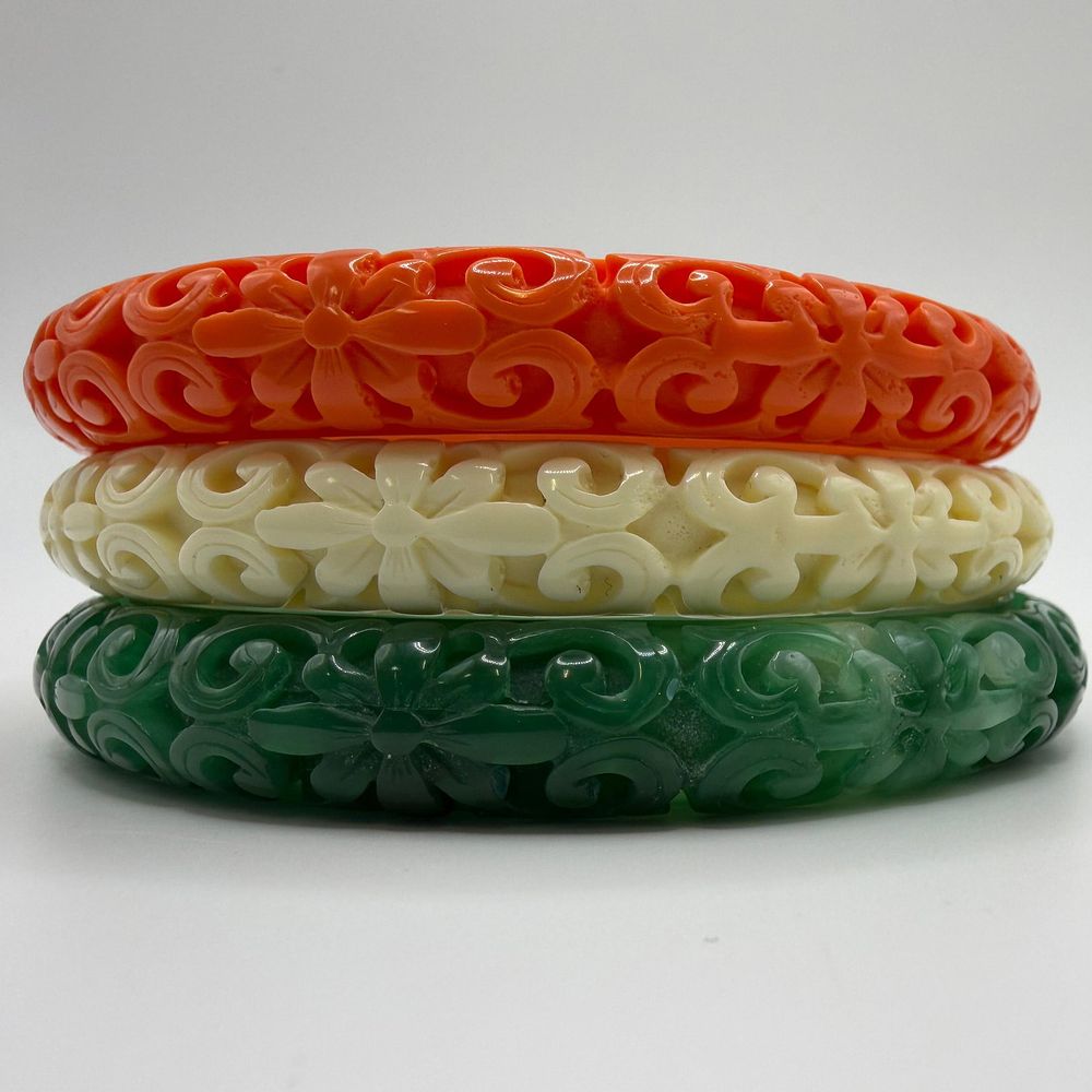 Lot 226: Kenneth Jay Lane Faux Jade Coral Ivory Tone Molded Lucite KJL Bangle Set