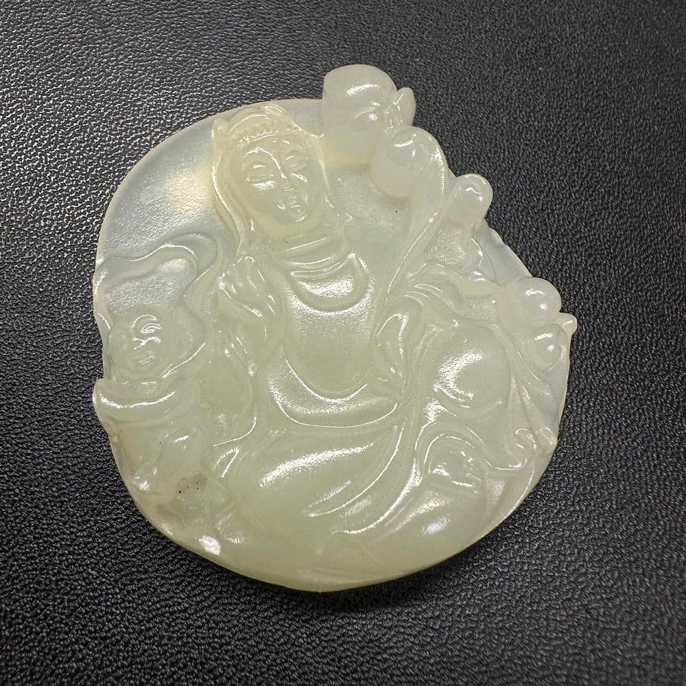 Lot 305: White "Mutton Fat" Jade Guanyin Pendant