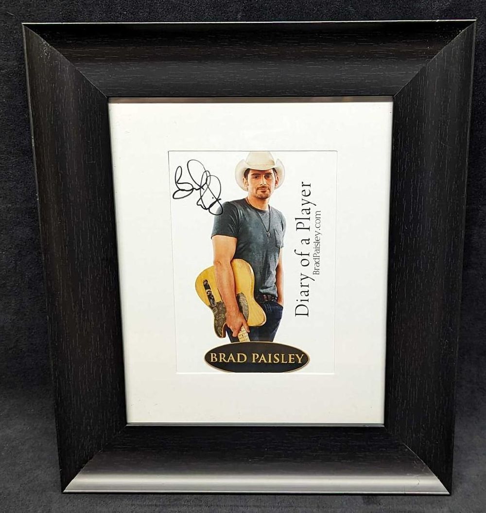 Lot 493: Framed Autographed Brad Paisley Book Print