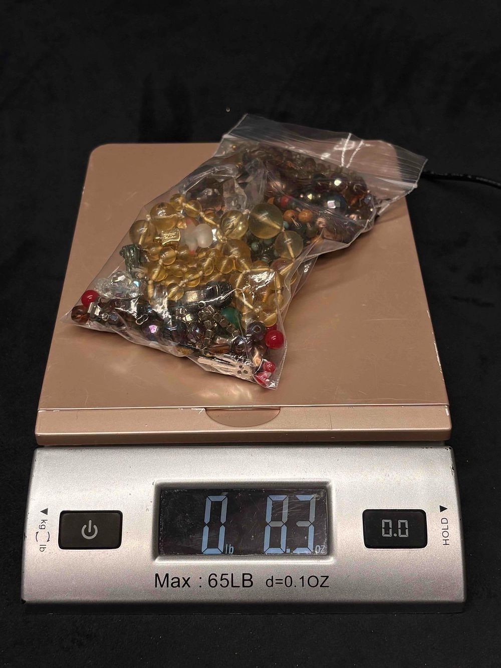 Lot 409: 8.3 OZ of Randomly Assorted Warm Tone Beads and Charms for Crafting