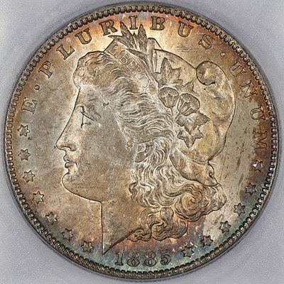 1885 O MS 64 ICG Morgan Silver Dollar TONED. A golden center radiates outward to reds and blues