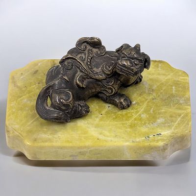 An Old Chinese Bronze Pixiu Mounted On Stone. Measures approx. 2" X 3 1/2". From the consignor: 