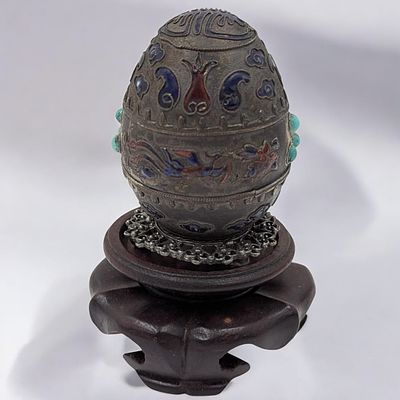 An Early Chinese Enamel And Silver Egg With Wooden Stand, 71 Grams. **DUE TO THIS LOT BEING 