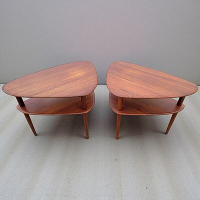Pair Of Mid Century Teak Two Tier End Tables. Measures approx. 23.5" X 29" X 20" each. 
Please 
