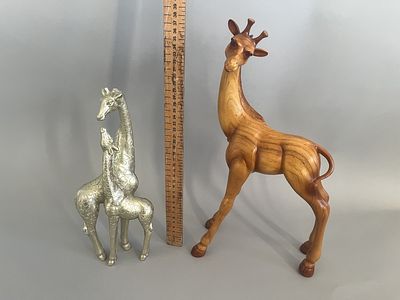 A Hand-Carved Wooden Giraffe Figurine and a Silver-Toned Giraffe Pair. This lot comprises two 