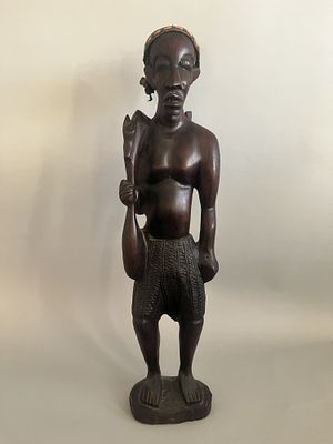A Carved Wood Kongo Figure. A large carved wood Kongo figure depicting a standing male. 