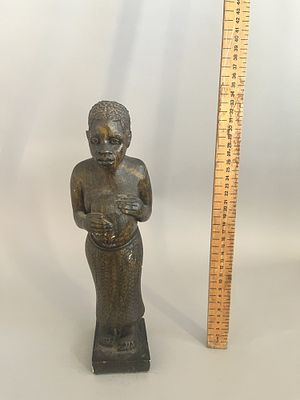 A Benin Tribal carved wooden figure depicting a standing human figure, likely female, with 
