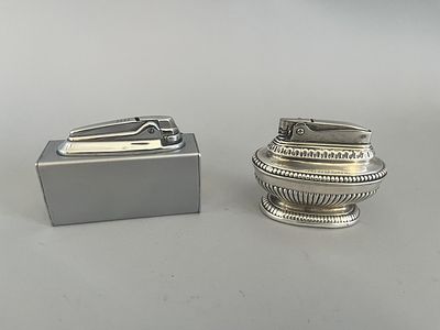 A pair of table lighters. The first is an ornate, traditional-style Ronson 'Queen Anne' table 