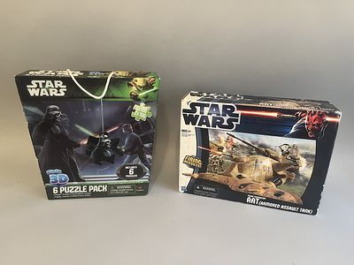 This lot comprises two Star Wars items in their original cardboard packaging. The first item is 