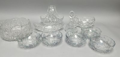 This lot comprises a collection of 10 clear glass serving pieces, presented in two distinct 