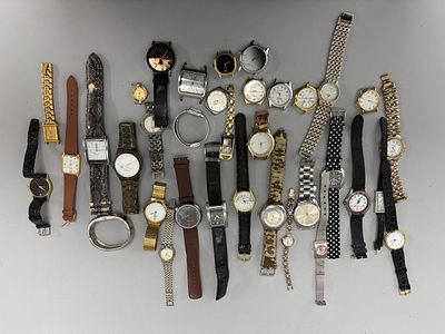 A collection of assorted wristwatches, primarily in gold-tone, silver-tone, for parts or repair.