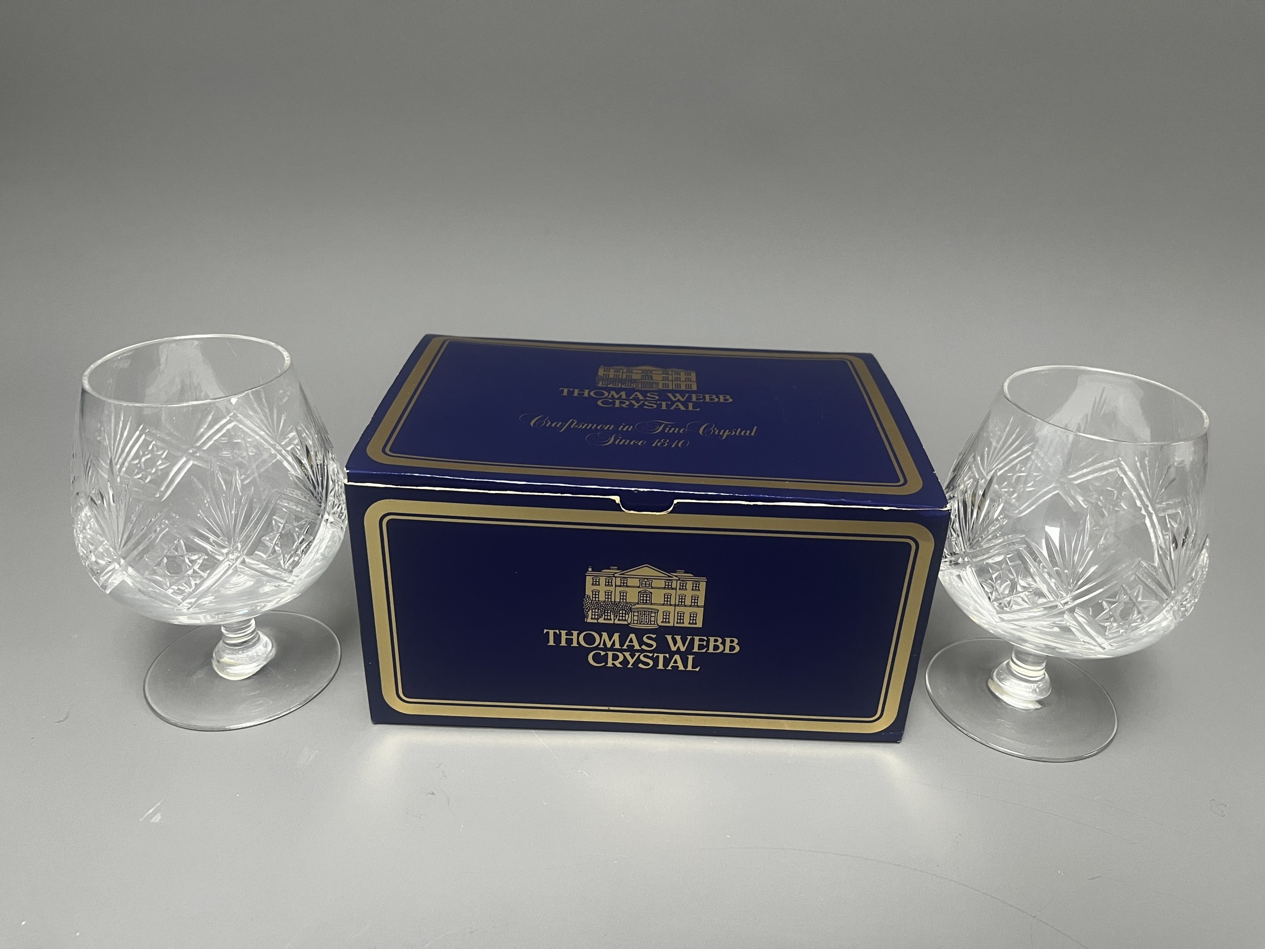 A pair of THOMAS WEBB lead crystal brandy balloons featuring deep hand-cut