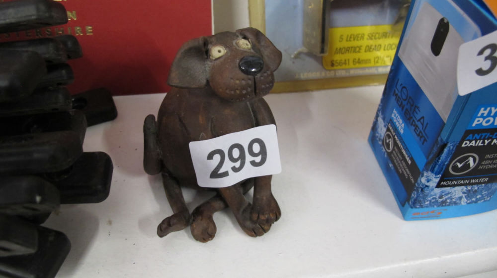 Lot 299: Cute hand made pottery dog ornament with a...