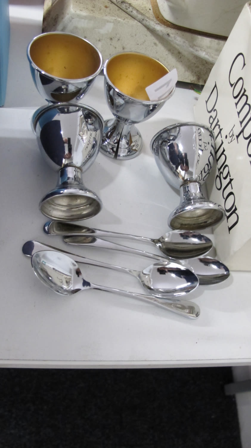 Lot 311: four plated egg cups and matching spoons