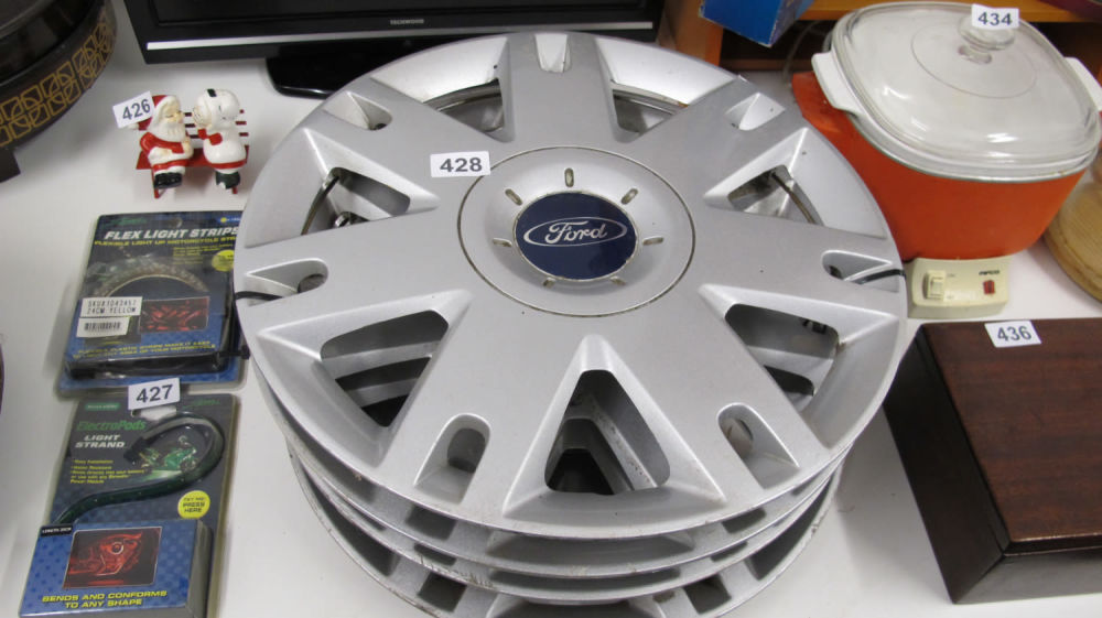 Lot 428: set of Ford car wheel trims