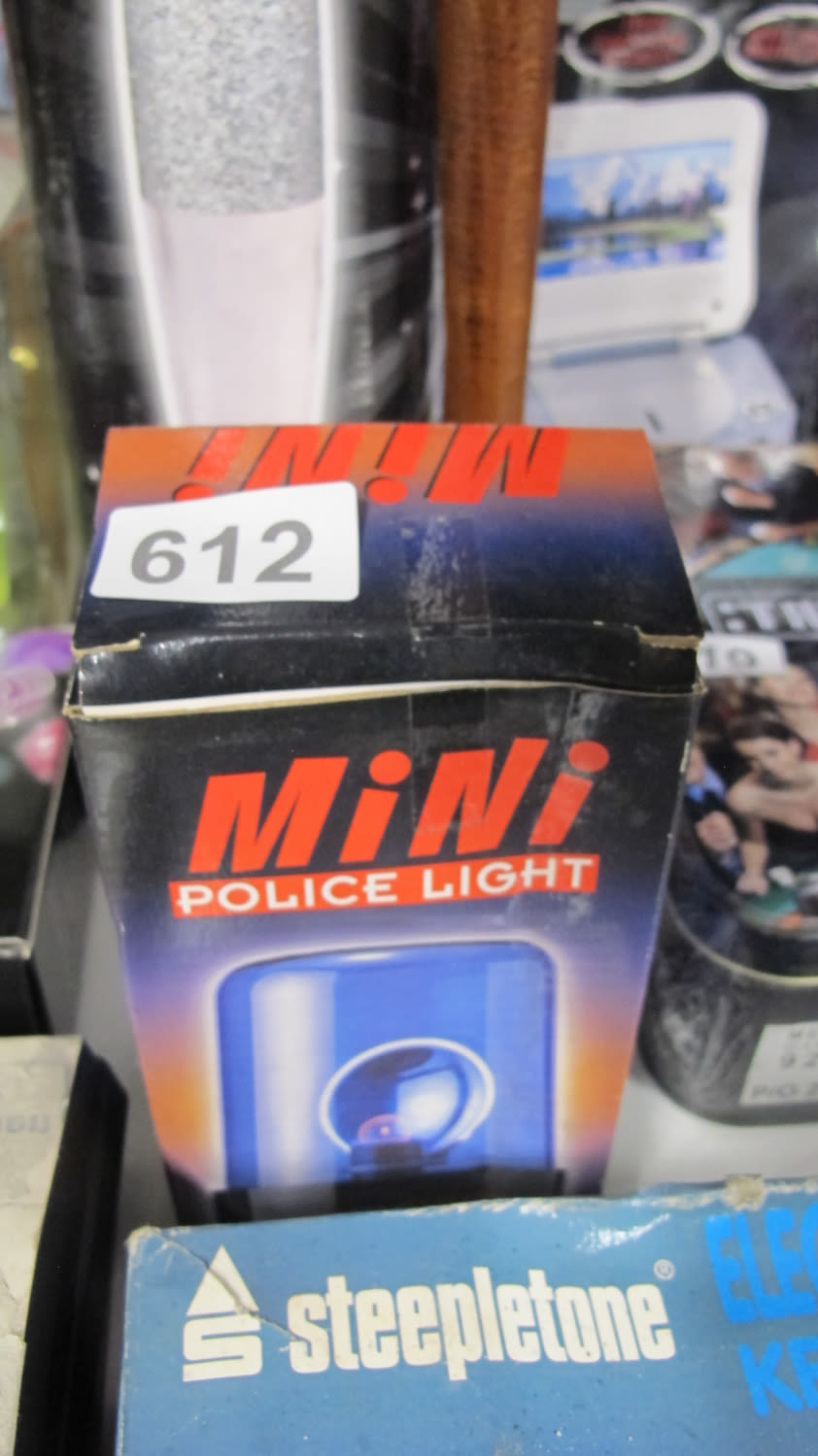 Lot 612: Mini police light to get the neighbours curtain...