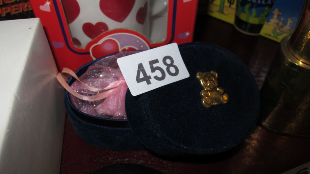 Lot 458: velvet teddy keepsake box with various bracelets inside