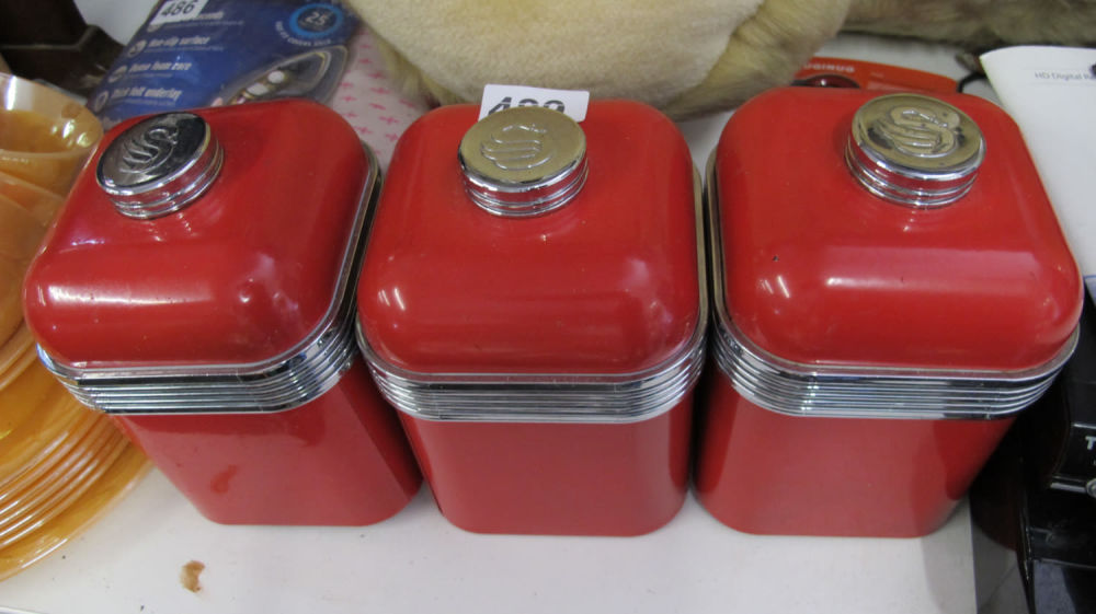 Lot 489: Red kitchen storage jars