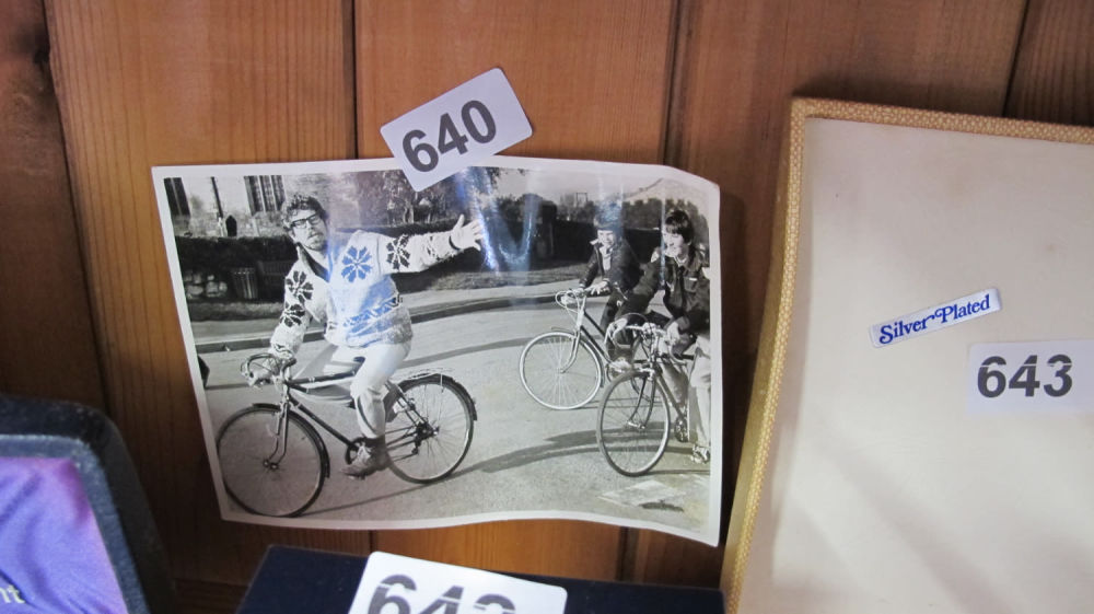 Lot 640: Press photo of Rolf Harris on a bike