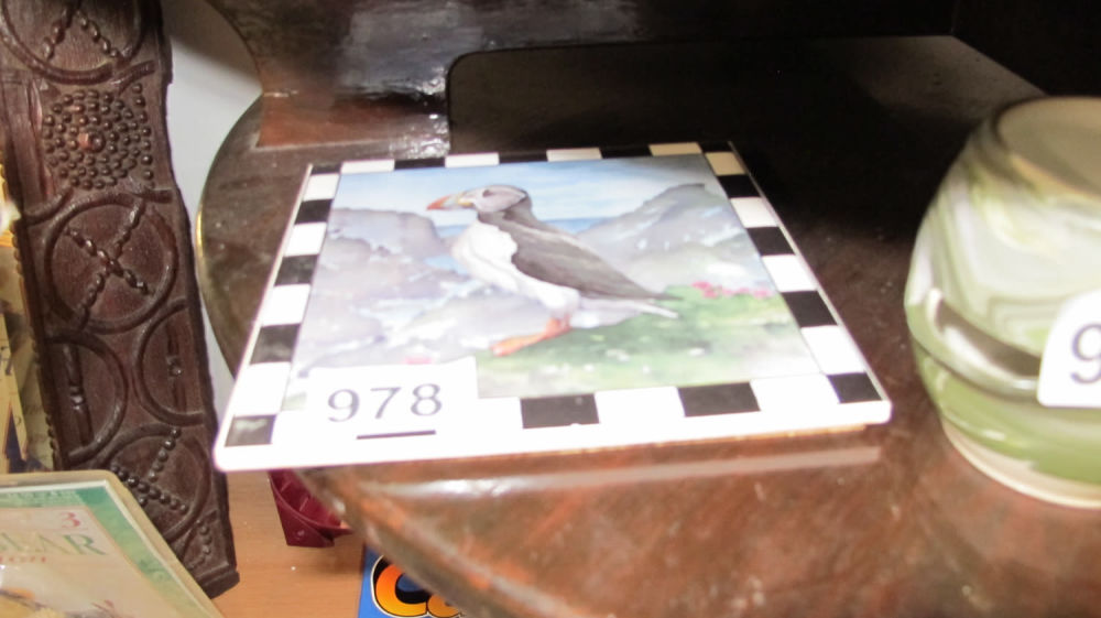 Lot 978: A hand painted puffin tile