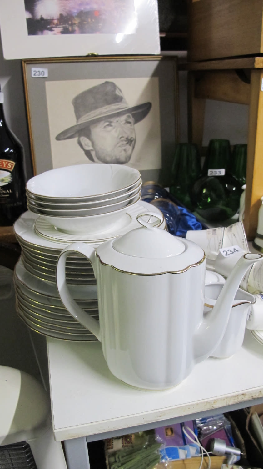 Lot 232: Gold rimmed white ceramic dinner service