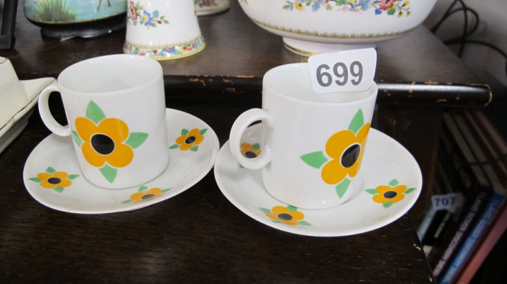 Lot 699: Floral design cups and saucers