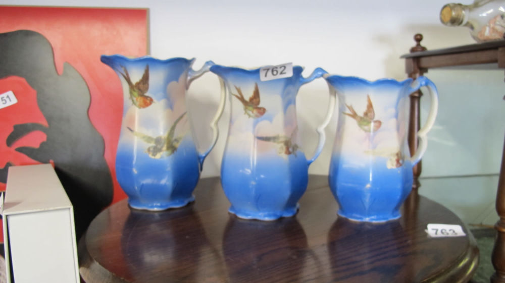Lot 762: 3 graduated painted jugs