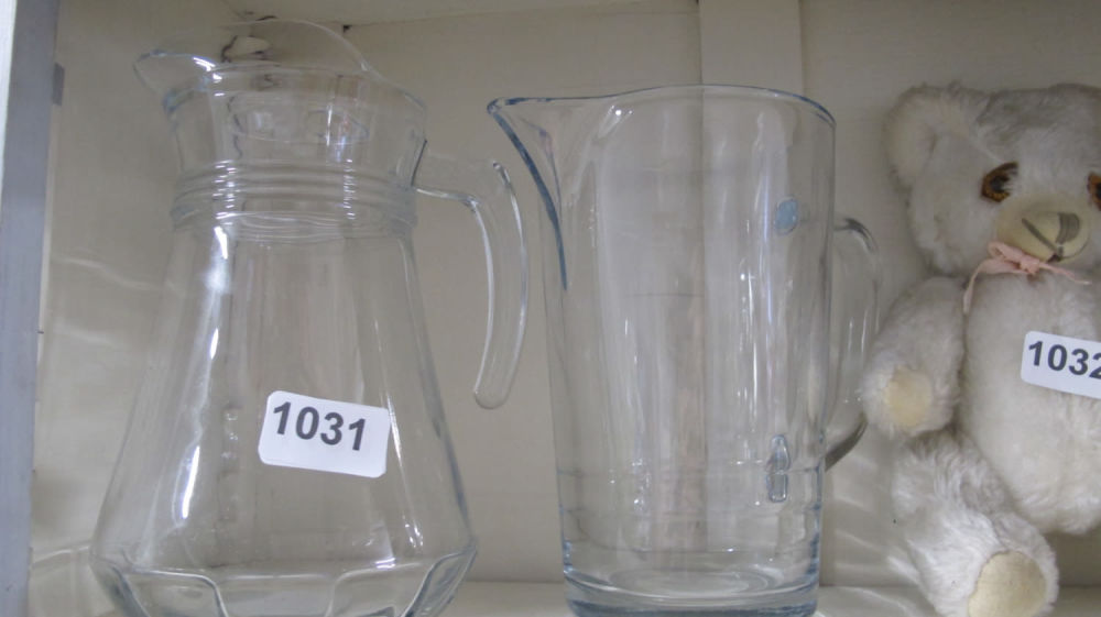 Lot 1031: Two glass water jugs
