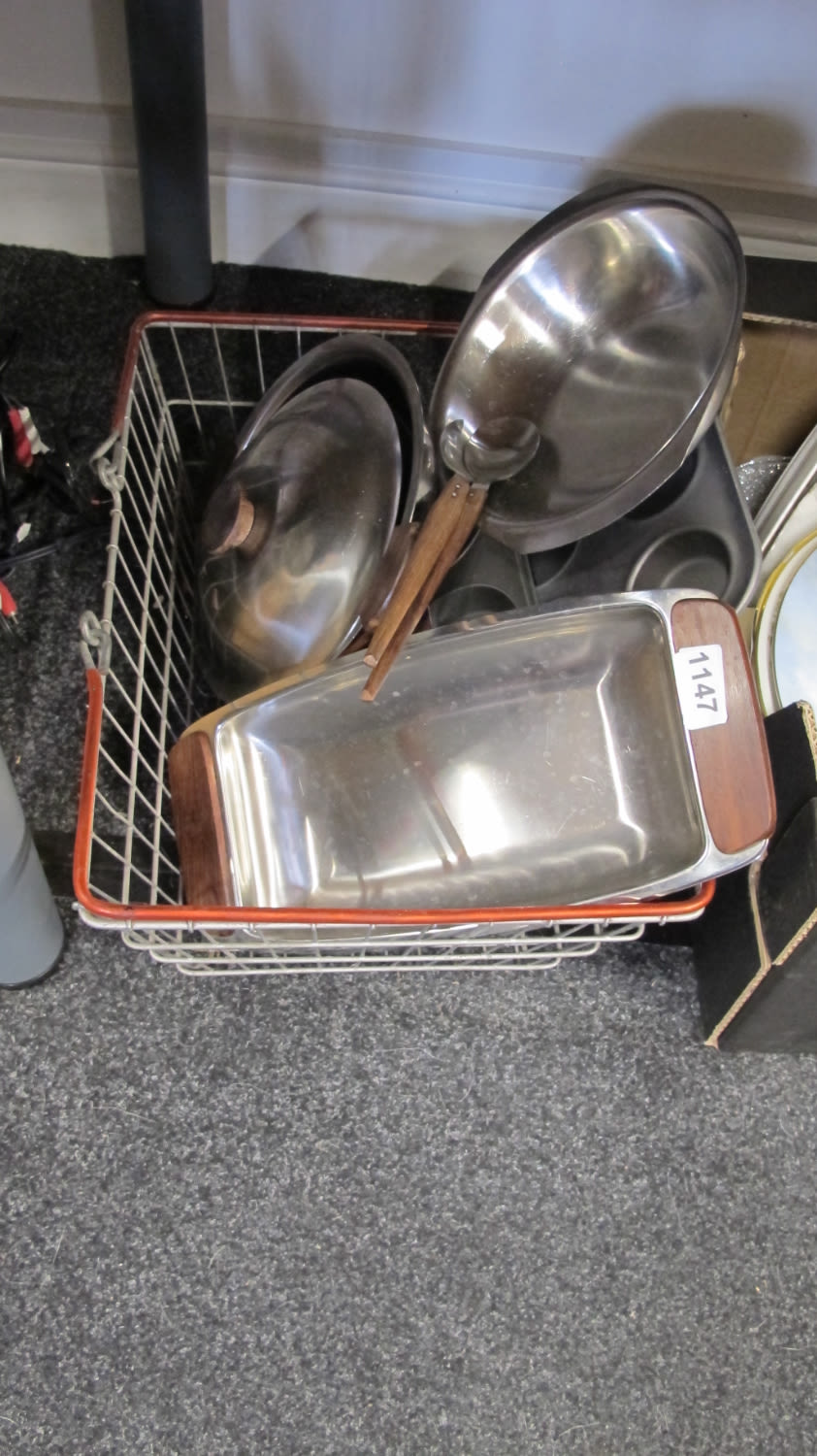 Lot 1147: Wire basket containing metal serving trays pans etc