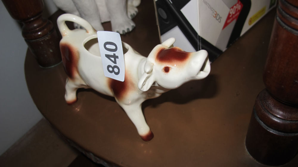 Lot 840: Cow milk jug