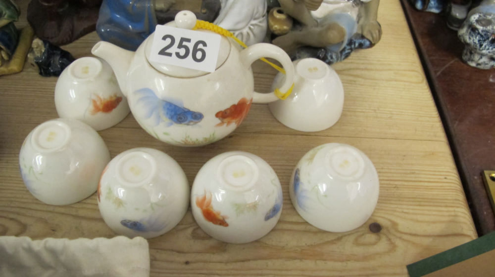 Lot 256: miniature Japanese tea pot and bowls