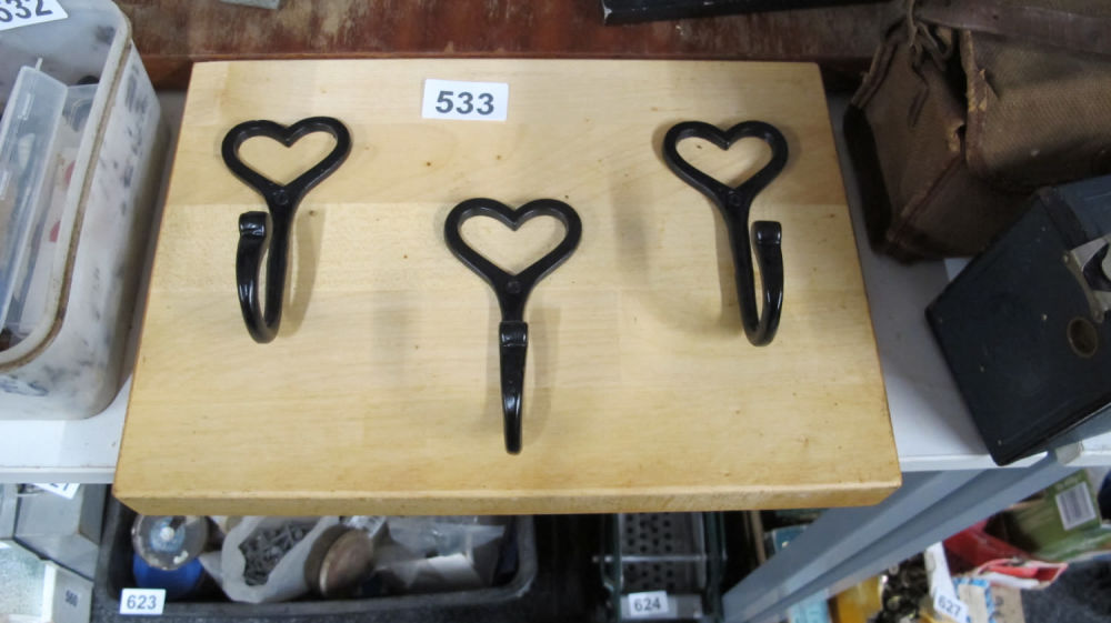 Lot 533: heart shaped coat hooks on a solid wooden...