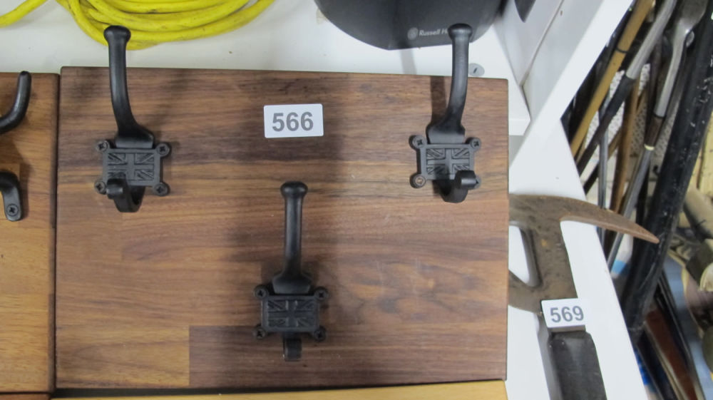 Lot 566: Solid wood coat rail with cast metal union...