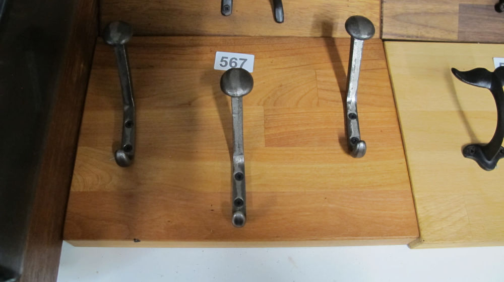 Lot 567: Solid wood coat rail with cast metal mountain...
