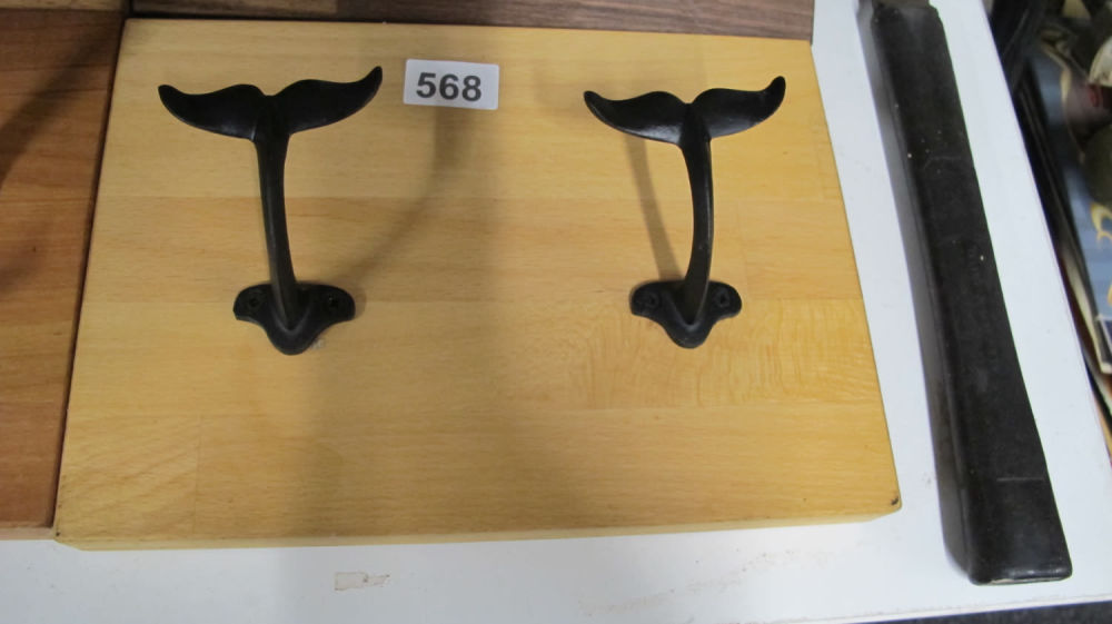 Lot 568: Solid wood coat rail with cast metal whale...