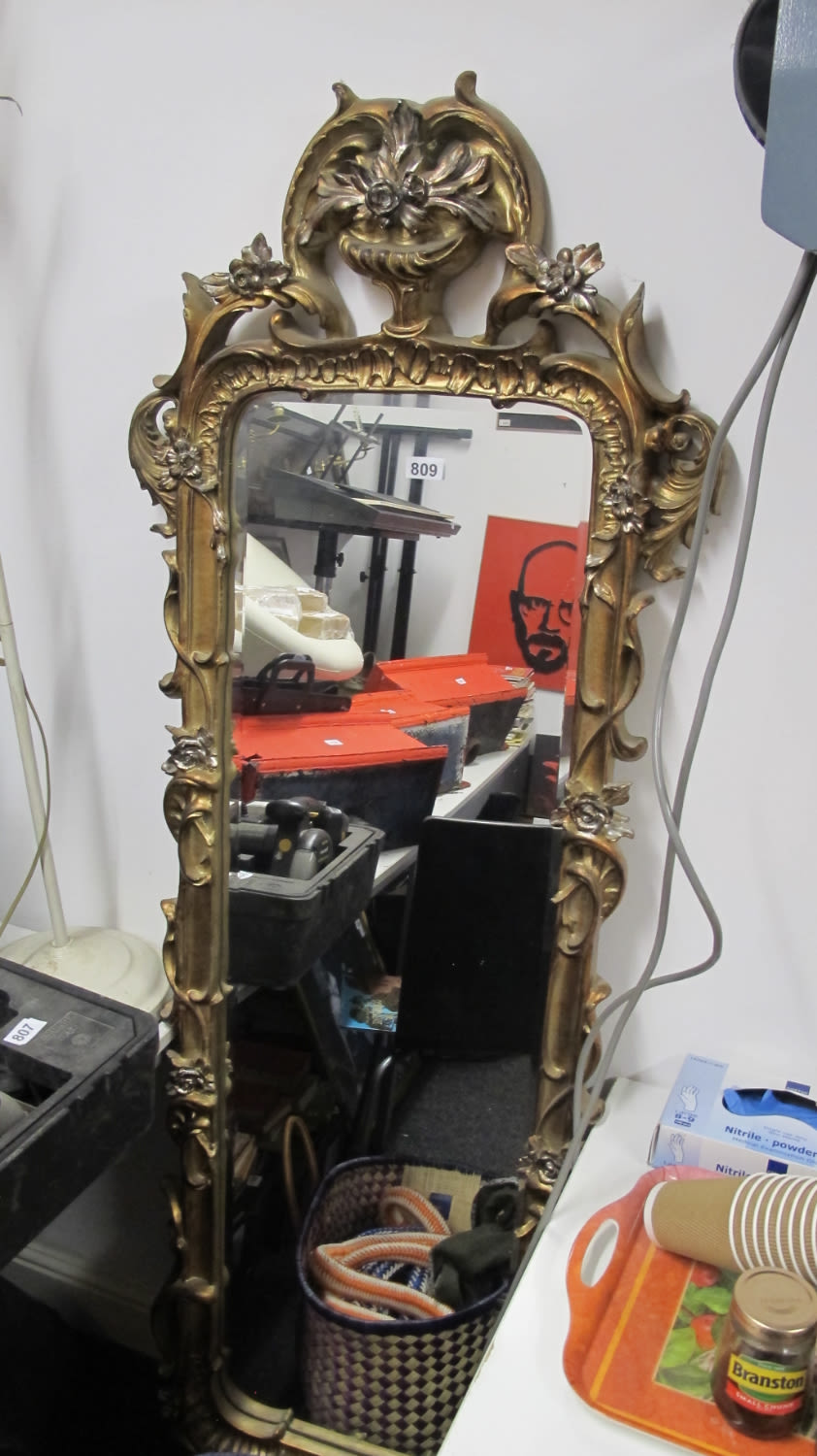 Lot 809: Ornately decorated gilt framed bevel edged mirror