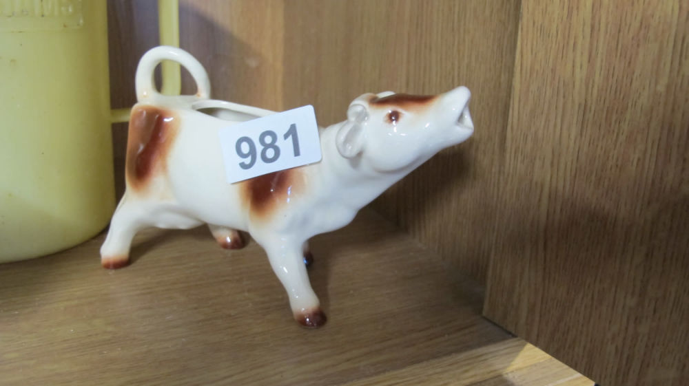 Lot 981: cow milk jug