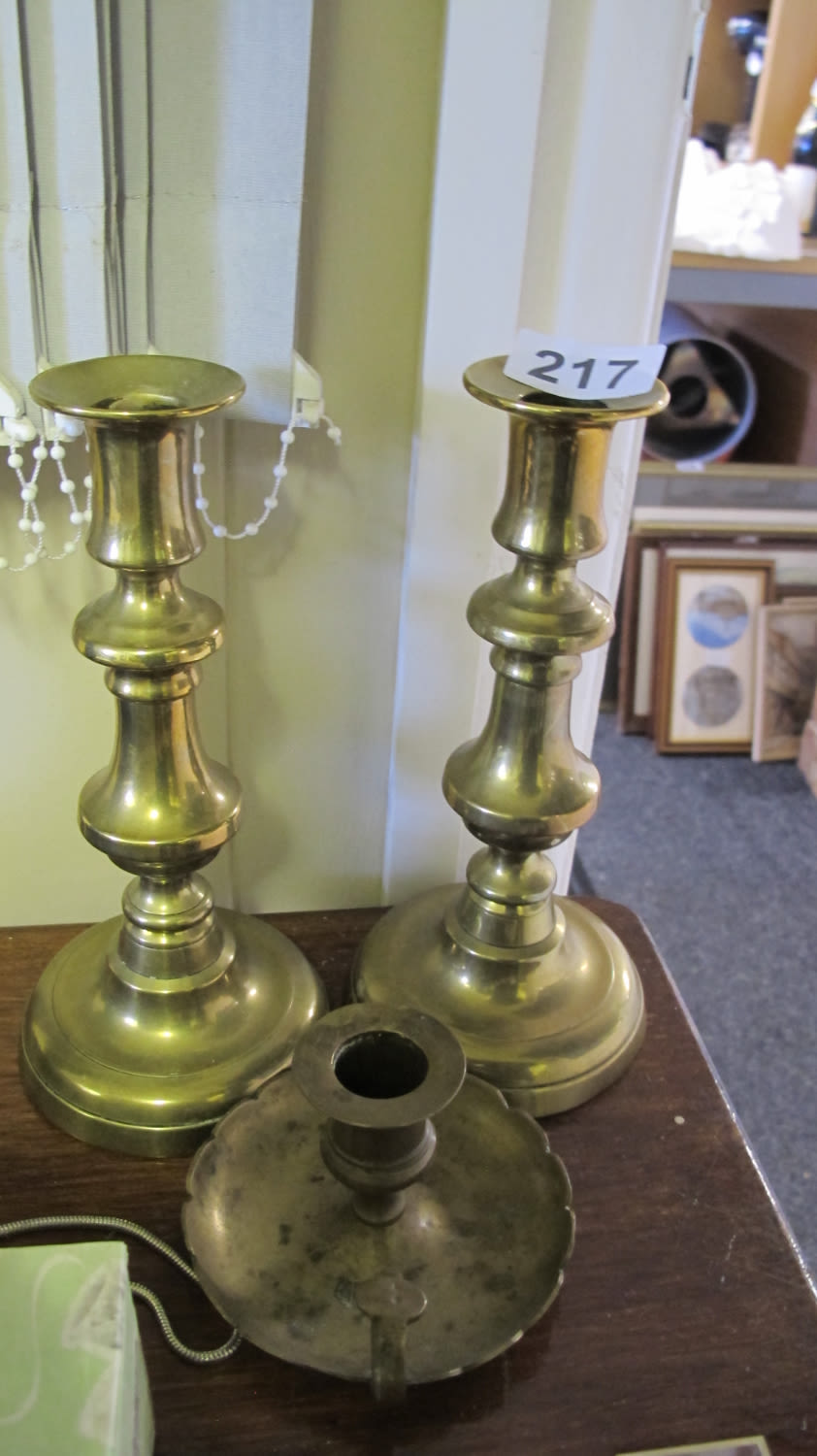 Lot 217: A pair of heavy brass candlesticks and a...