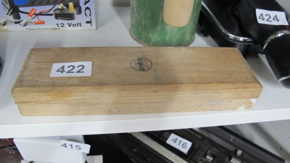 Lot 422: sharpening stone in wood surround