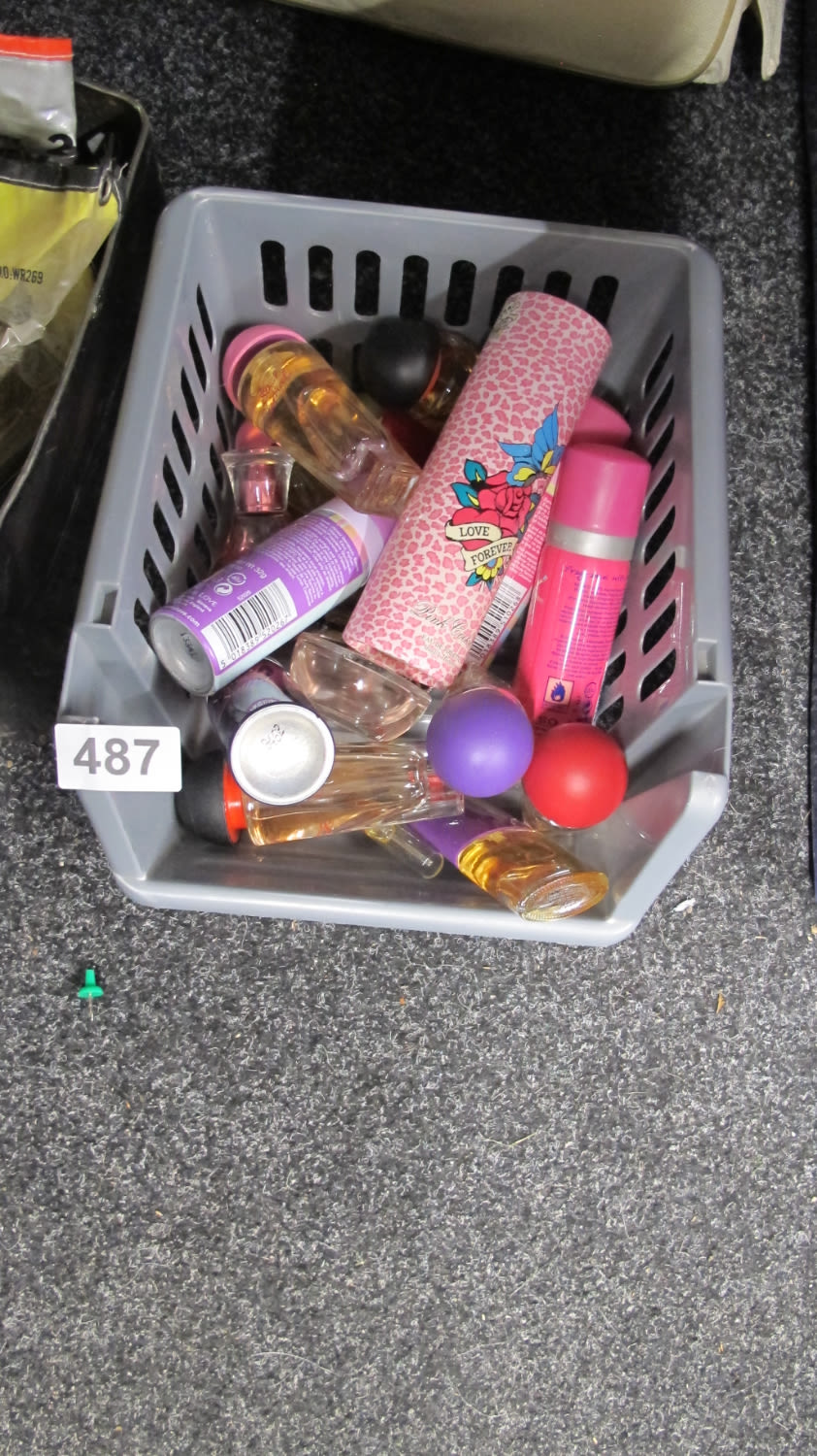 Lot 487: A tub of perfumes, body sprays, etc.