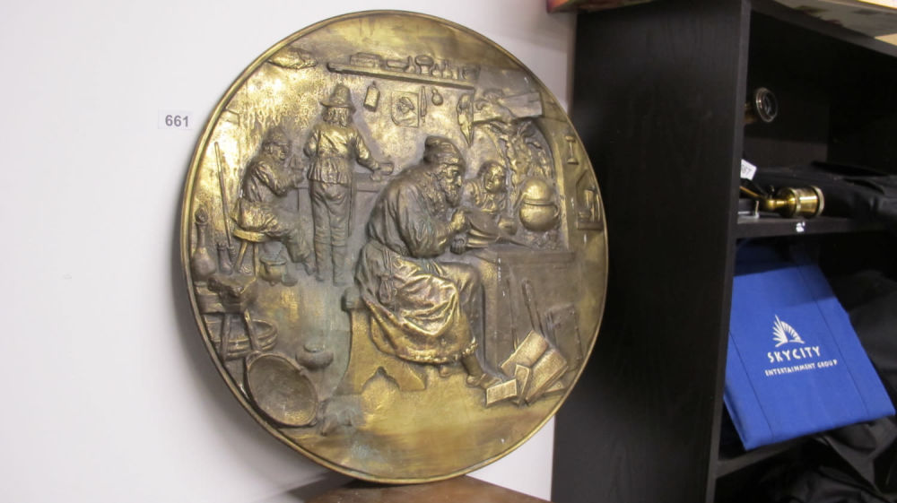 Lot 661: Very large antique brass wall charger