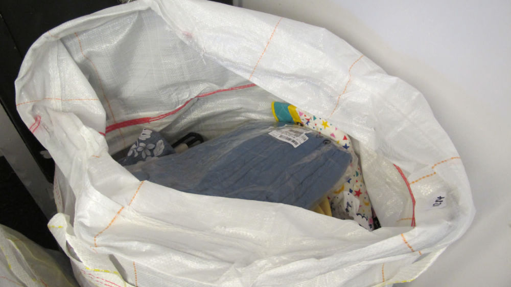 Lot 1284: a large bag of new clothing