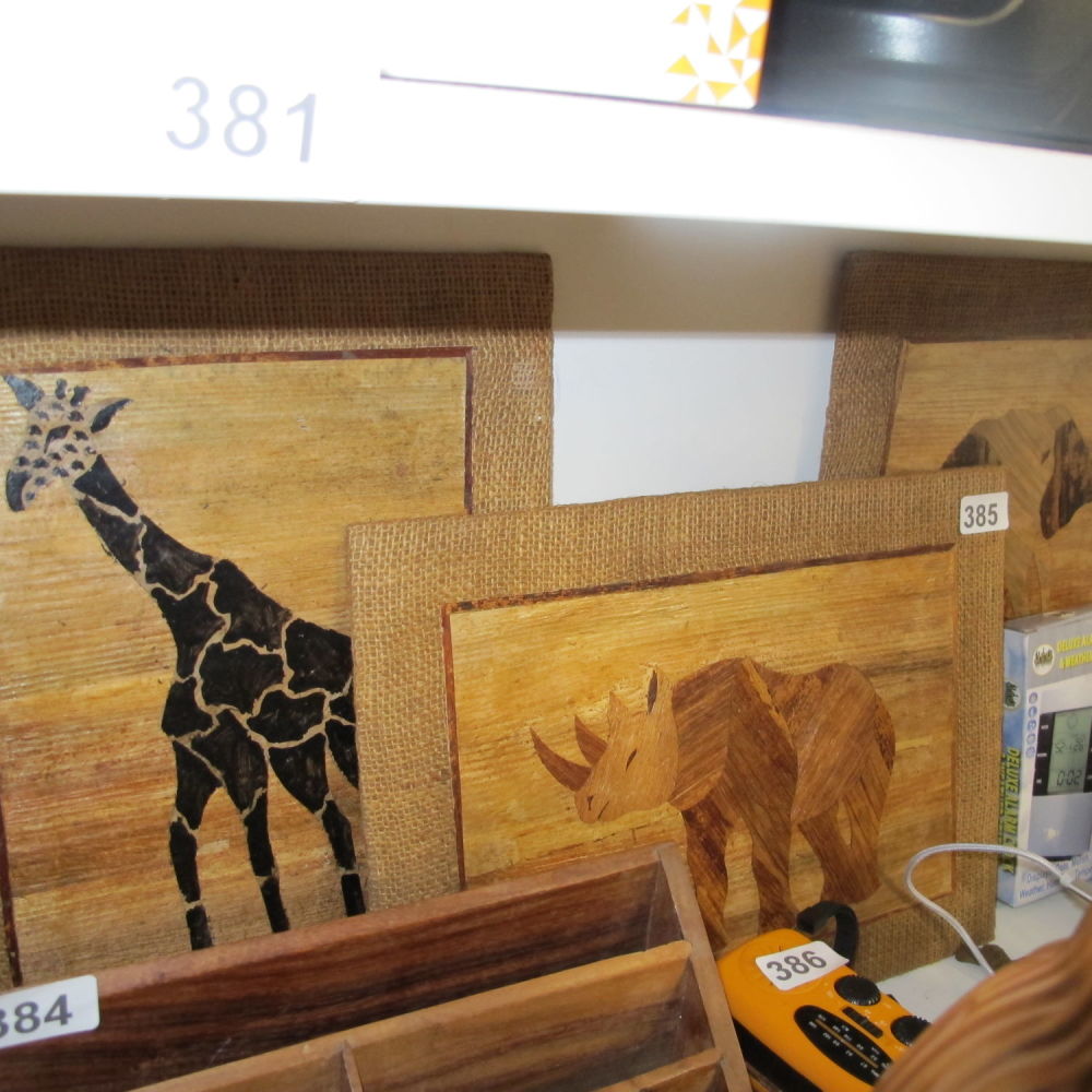 Lot 385: Three wooden pieced marquetry plaques featuring African animals