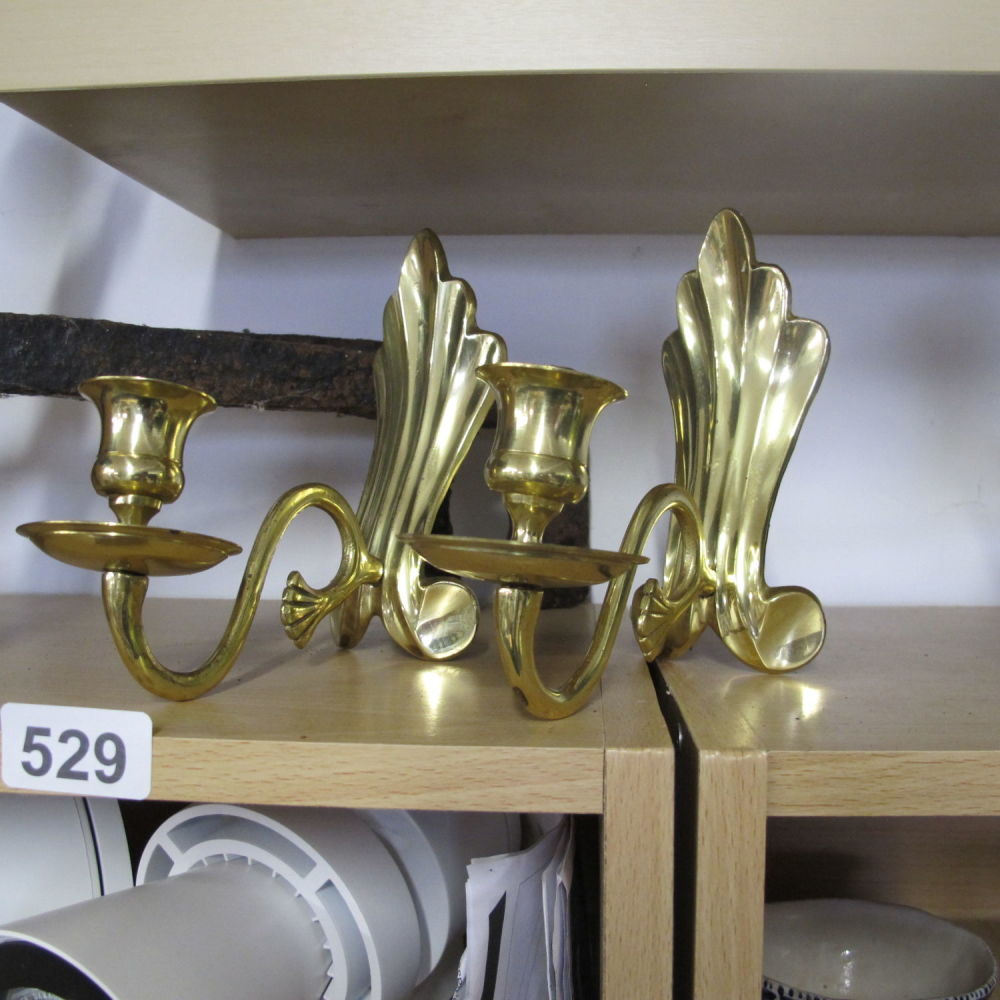 Lot 529: a pair of brass ornate candle stick holders