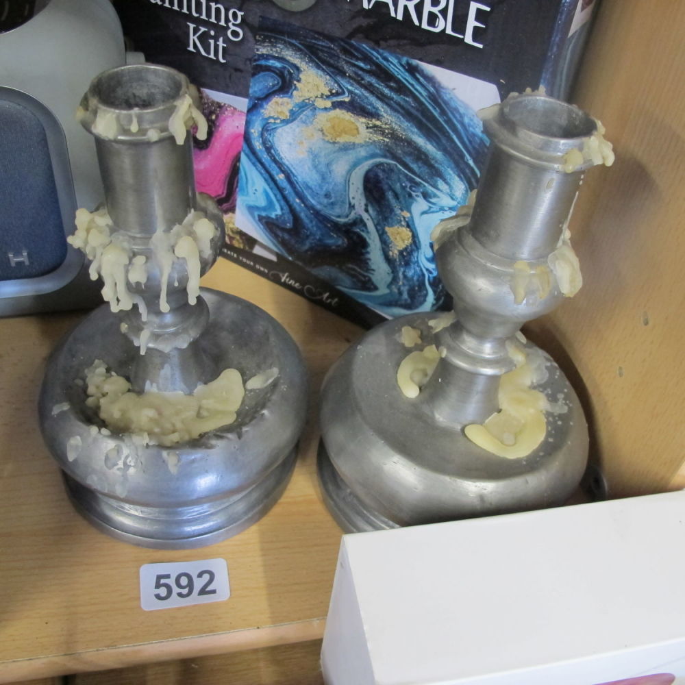 Lot 592: A pair of pewter vintage candle sticks