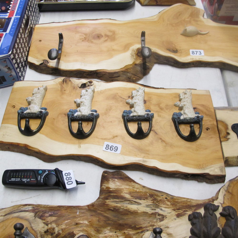 Lot 869: Wooden coat rack with cast metal dog hook...
