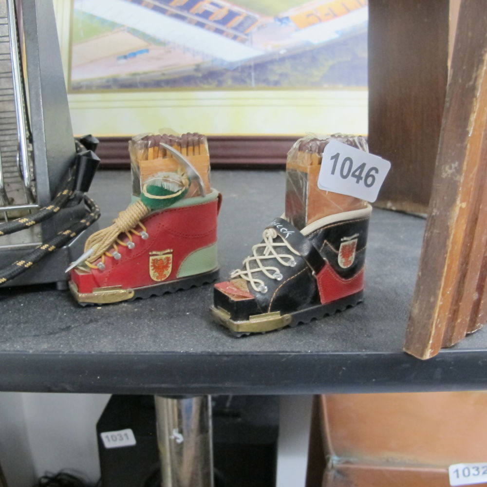 Lot 1046: Two boot shaped matchstick holders ***