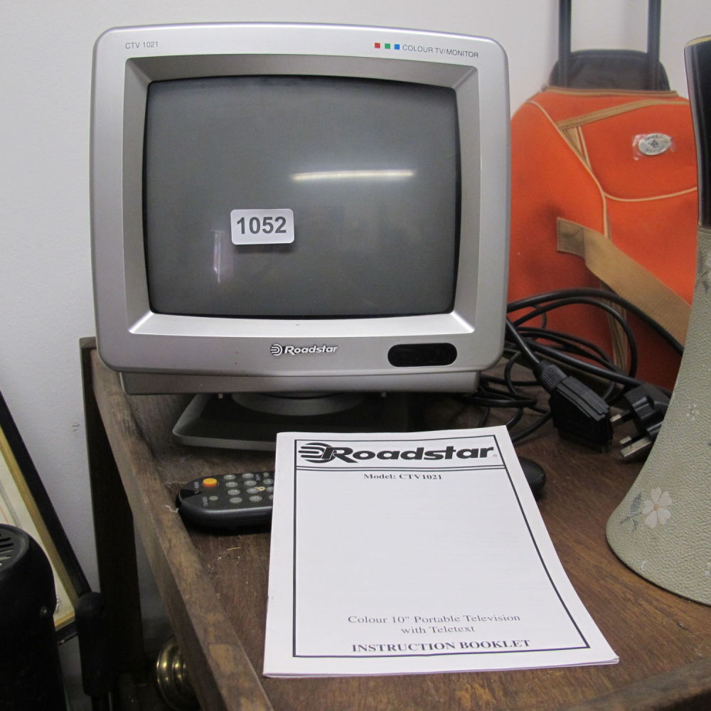 Lot 1052: Roadstar CTV1021 10” portable television with manual and...